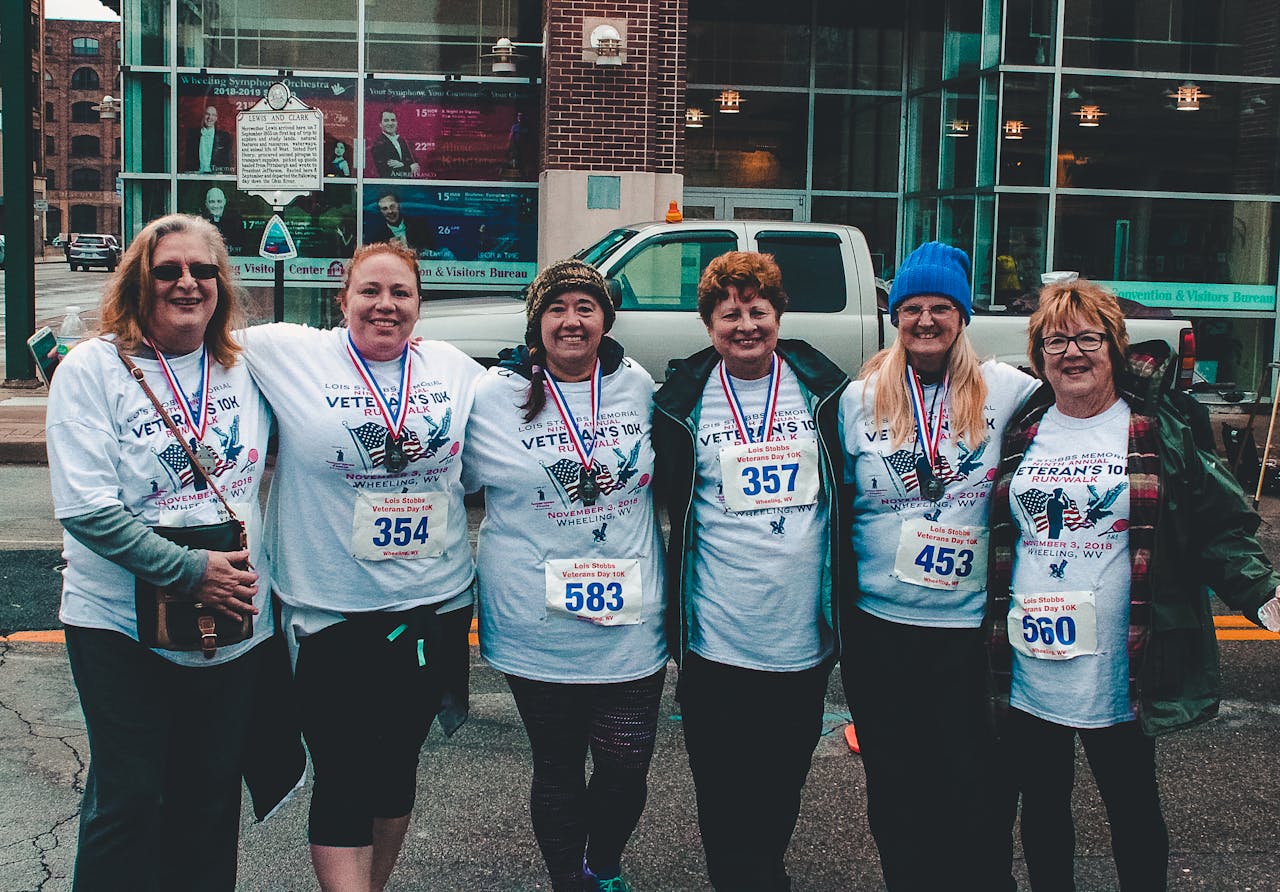 Crafting Captivating Headlines: Your awesome post title goes here Six women participate in a Veterans Day 10K run wearing matching shirts and medals.