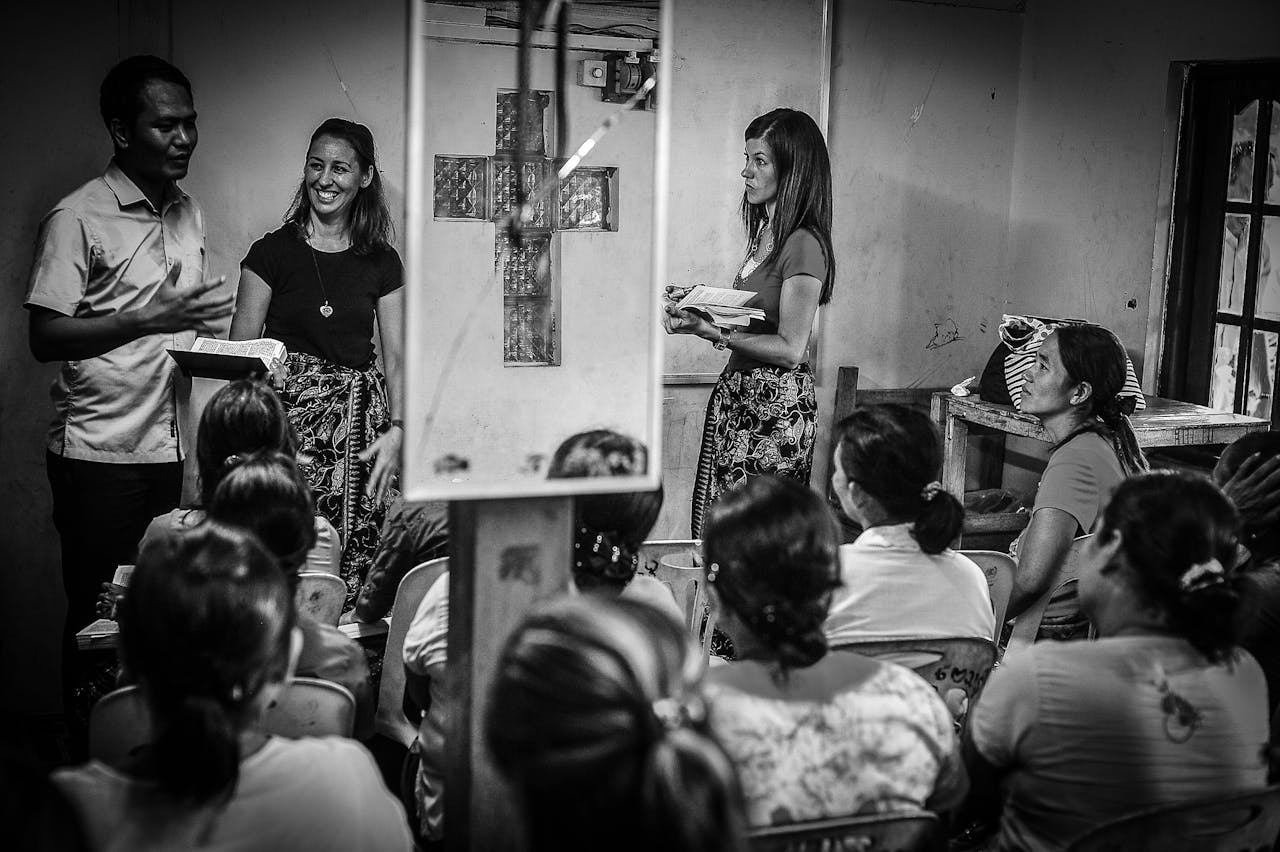 services-04 A diverse group of people gather in a room for an educational seminar.